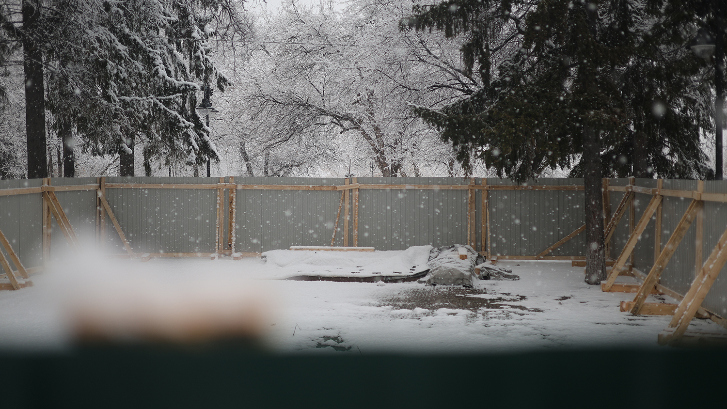 Если заглянуть за забор: вид на демонтированный мемориал “Камень скорби” в Сквере памяти, напротив администрации города Томска.